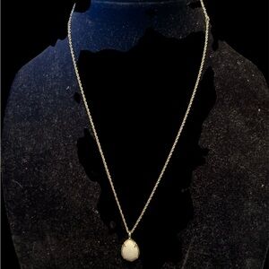 Kendra Scott gold necklace featuring a white Mother of Pearl